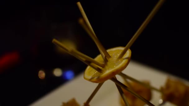 Cheese dish on a stick with a lemon — Stock Video