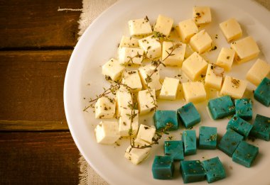 Peynir tabağı, Gouda, beyaz, mavi pesto peynir üzerinde otlar, zeytinyağı, nar ve hardal sos ile plaka beyaz