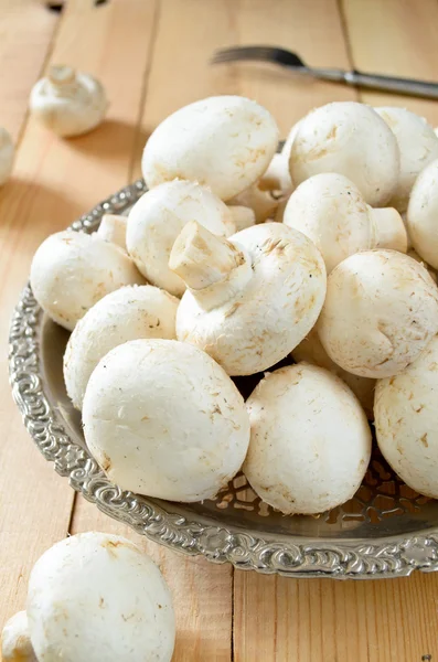 Raw champignons on wooden background — Stock Photo, Image