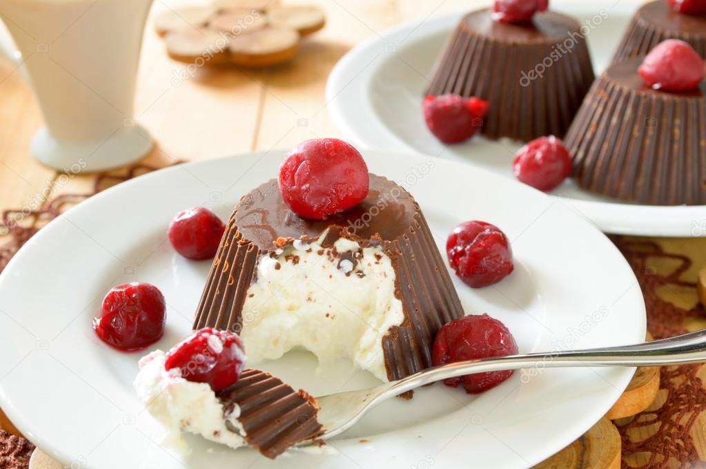 Homemade custard ice cream, covered with chocolate and cherries