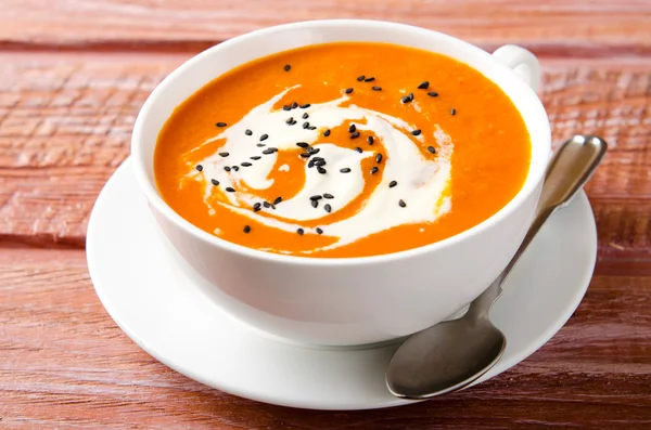 Pumpkin Soup with tomatoes, chili, yogurt and black sesame seeds — Stock Photo, Image