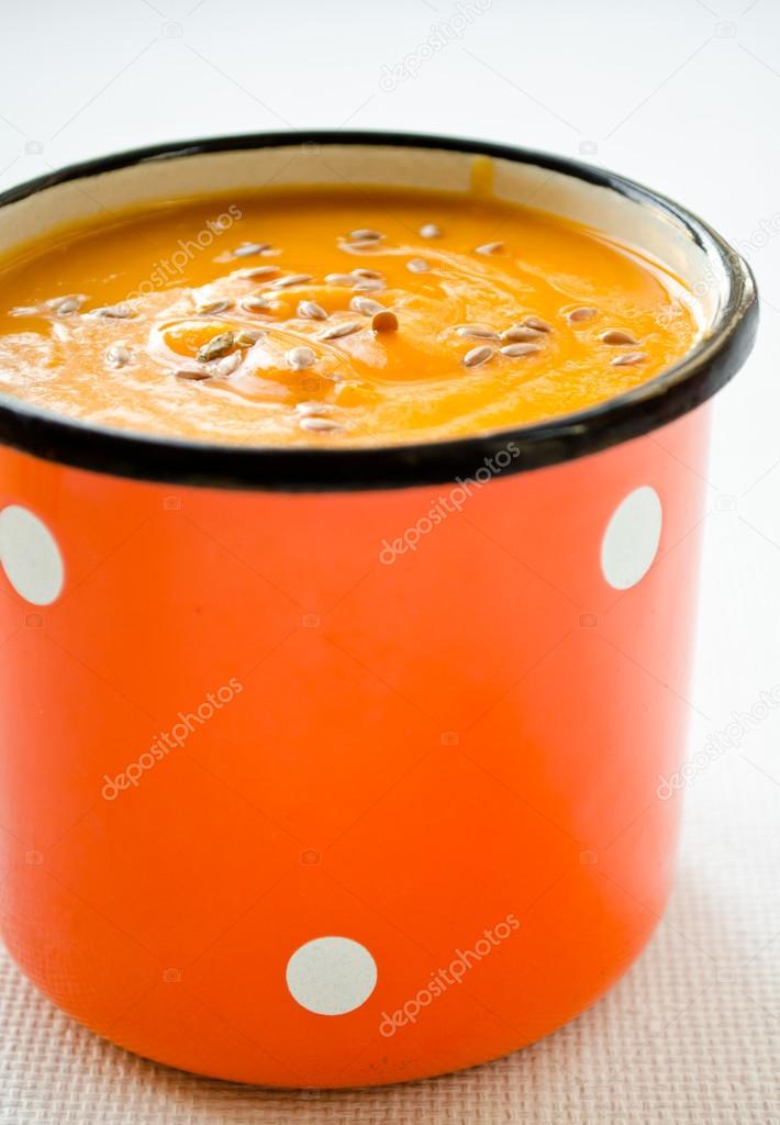 Vegetarian carrot-pumpkin cream soup with flax seeds