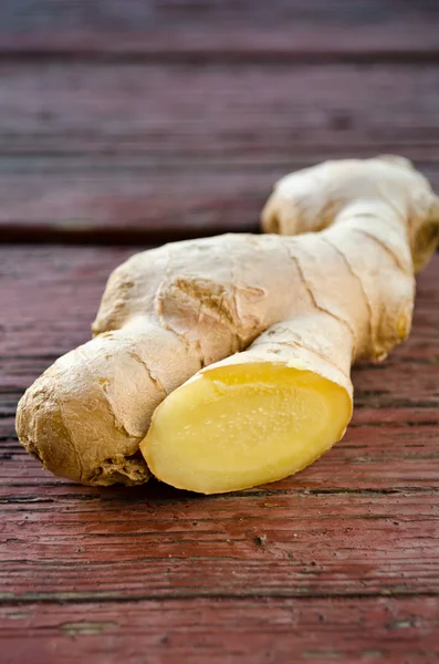 Ginger root sliced on wooden table — Stock Photo, Image