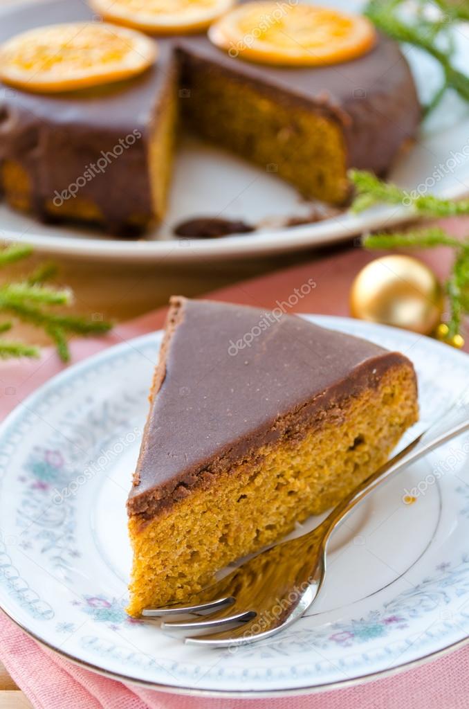 Carrot cake with chocolate topping and caramelized oranges