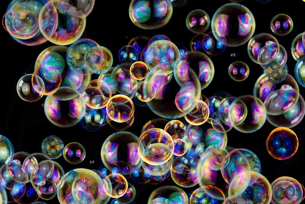 Colorful soap bubbles on black background — Stock Photo, Image