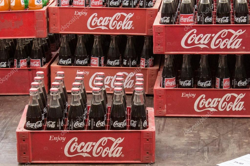 Phnom Penh, Cambodia- January 02,3024: Coca Cola bottles in red plastic box, vintage style. Coca cola is probably the worlds most famous brand.