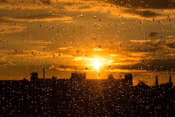 Rain drops on  window st sunset sky — Stock Photo, Image