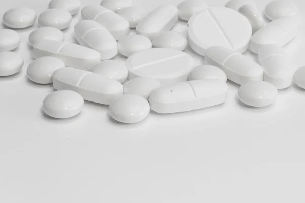 White pills on white background — Stock Photo, Image