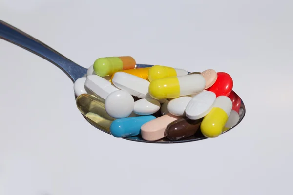 Pills on spoon , medicine macro — Stock Photo, Image
