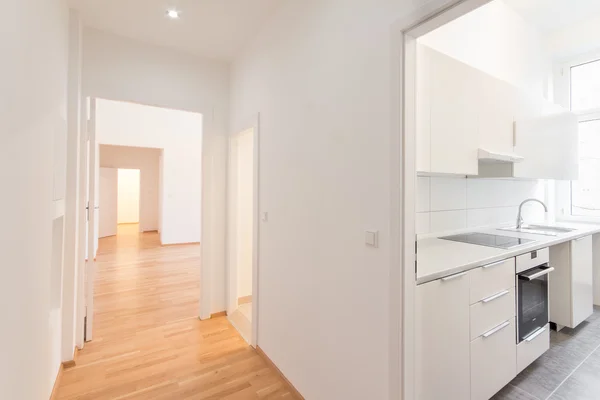 Renovated flat , corridor and kitchen, white walls and wooden — Stock Photo, Image