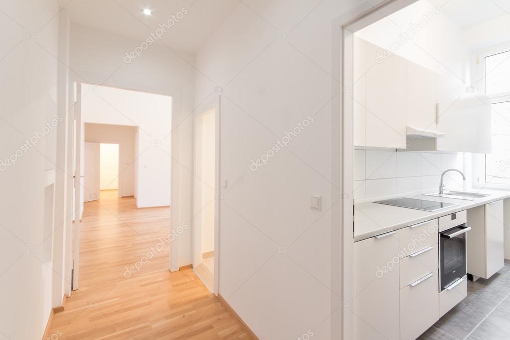 renovated flat , corridor and kitchen, white walls and wooden
