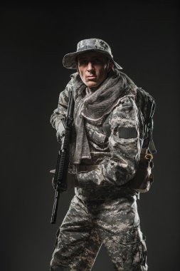 Special forces soldier man with Machine gun on a  dark background clipart