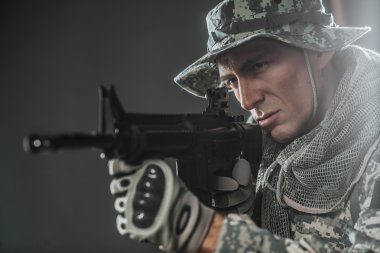 Special forces soldier man with Machine gun on a  dark background clipart