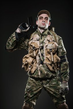 Soldier man hold Machine gun on a  dark background clipart