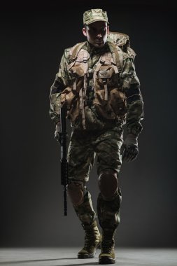 Asker adam tutun makineli tüfek karanlık bir arka plan üzerinde