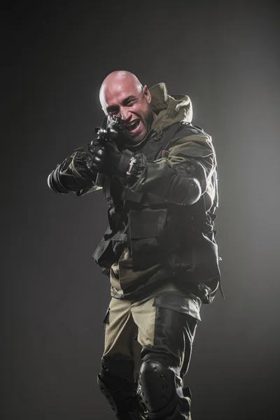 Soldier man hold Machine gun on a  dark background — Stock Photo, Image