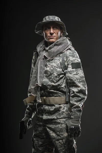 Karanlık bir arka plan üzerinde silahlı Özel Kuvvetler asker adam