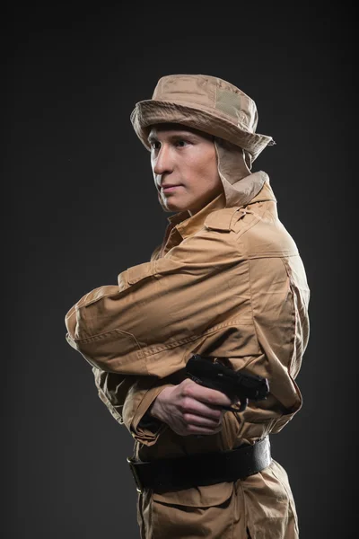 Soldier with a gun on dark background — Stock Photo, Image