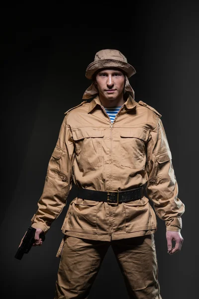 Soldier with a gun on dark background — Stock Photo, Image