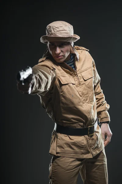 Soldier with a gun on dark background — Stock Photo, Image