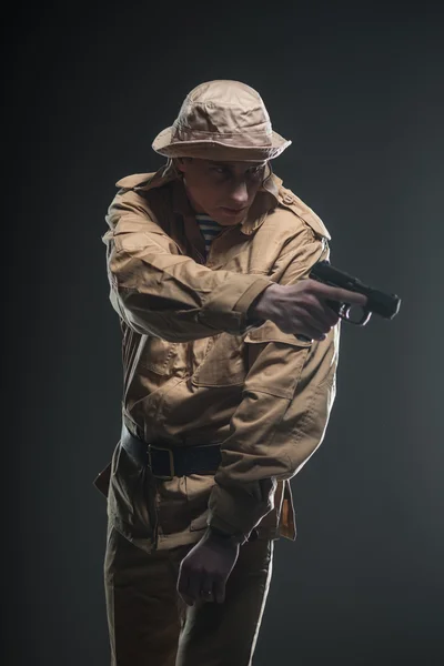 Soldier with a gun on dark background — Stock Photo, Image