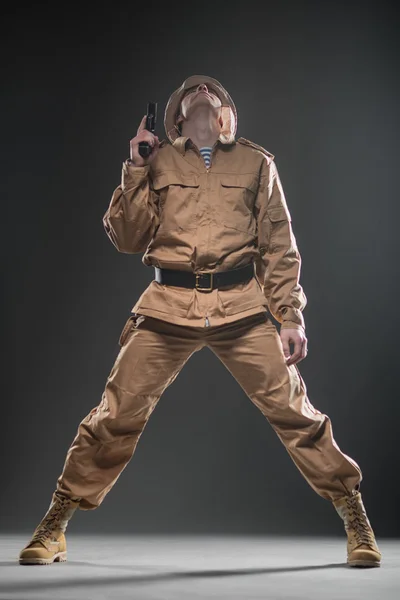 Soldier with a gun on dark background — Stock Photo, Image