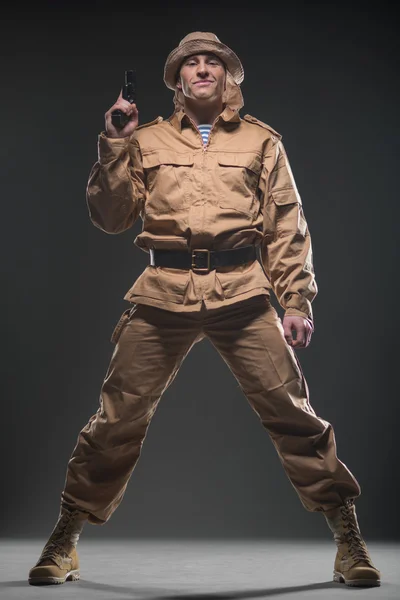 Soldier with a gun on dark background — Stock Photo, Image