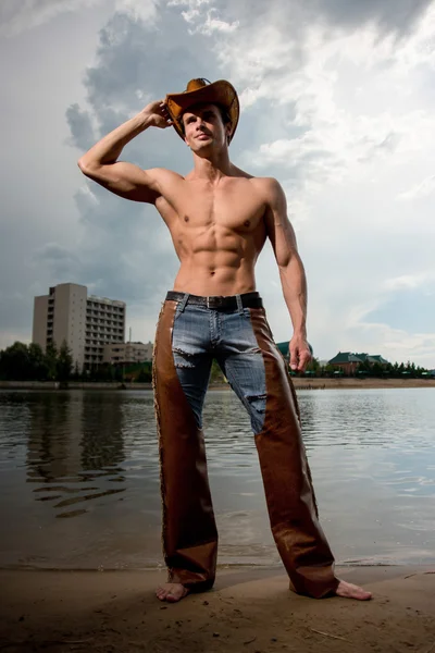 Sporty, athletic, muscular sexy man in a cowboy outfit — Stock Photo, Image