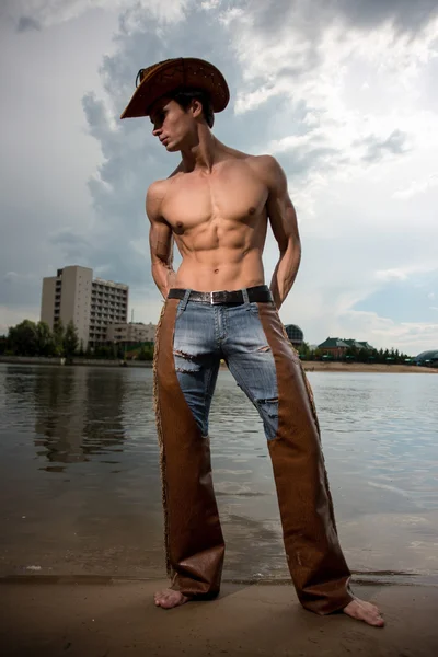 Sporty, athletic, muscular sexy man in a cowboy outfit — Stock Photo, Image