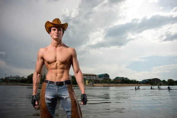 Sporty, athletic, muscular sexy man in a cowboy outfit — Stock Photo, Image