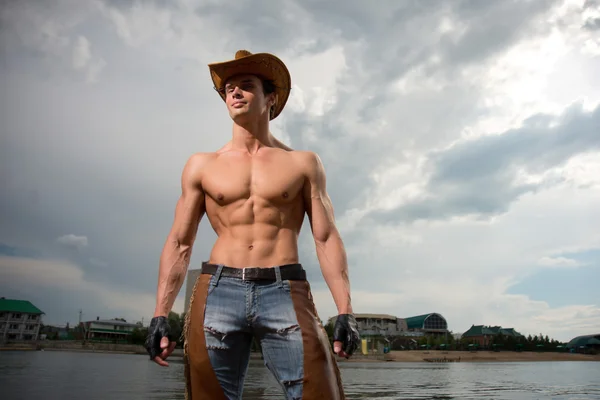 Sporty, athletic, muscular sexy man in a cowboy outfit — Stock Photo, Image