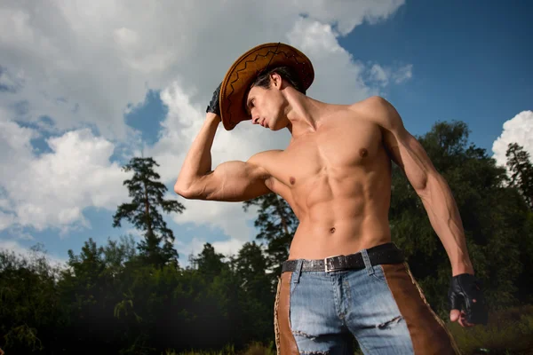 Sporty, athletic, muscular sexy man in a cowboy outfit — Stock Photo, Image