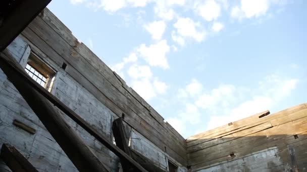 The roof fell into the old wooden ruined church, the sky is clear — Stock Footage The roof fell into the old wooden ruined church, the sky is clear Royalty Free Stock Footage