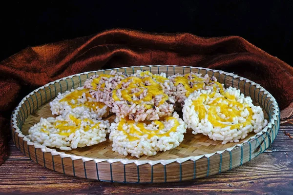 Rice cracker or Khaotan, local famous dessert of traditional ceremony in Northern Thailand, made from white and black glutinous rice and sugar cane syrup. Thai crispy rice cake with cane sugar drizzle