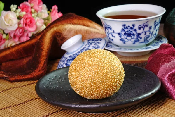 Sesame Ball is fried dessert balls made of flour stuffed with seasoning mung bean, red bean, black bean or peanut paste and coated with white sesame. Also known as Dragon balls, Famous  Chinese snack