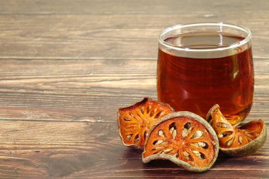 Bangal bıldırcın meyveli bitki çayı. Bael meyvesi antiinflamatuar özelliğe sahiptir, sindirim bozukluklarını iyileştirmeye yardımcı olur, astım için ilaç olarak kullanılır ve nezle için de kullanılır. Kopyalama alanı ile seçmeli odak.