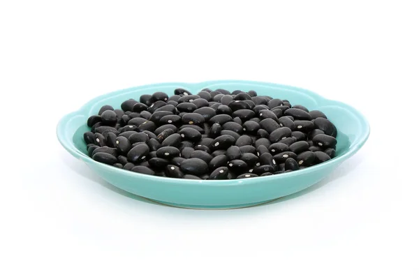 白を基調とした料理に黒亀豆 伝統的な中国医学の面で黒豆は 血液や陰を強調する能力のために知られています 水を調節します — ストック写真
