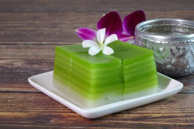 Thai dessert : Steamed Layer sweet cake (or Khanom Chan) Thai traditional dessert (Green Pandan flavour). One of nine famous Thai auspicious desserts in Thailand. Selective focus,copy space. clipart