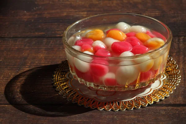 Colorful glutinous rice balls in sweet syrup (Tangyuan or Yuanxiao) Chinese Traditional dessert for Dongzhi Festival (Winter Solstice Festival) and Yuanxiao Festival. Selective focus, copy space.