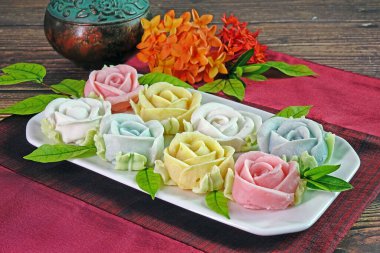 Allure rose candy, famous Royal Thai cuisine. Made from coconut milk, wheat flour and sugar. Colorful roses shaped candy from Thailand. Copy space