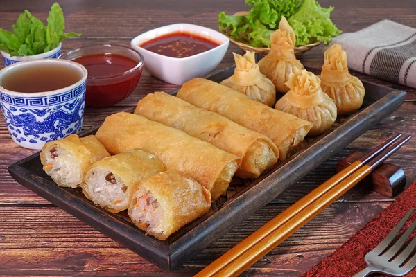 Spring rolls and Wontons. Deep fried crispy spring rolls and deep fried crispy wontons. Famous Traditional Chinese appetizers, served with sweet chili sauce or sweet plum sauce. Chinese tea time snack
