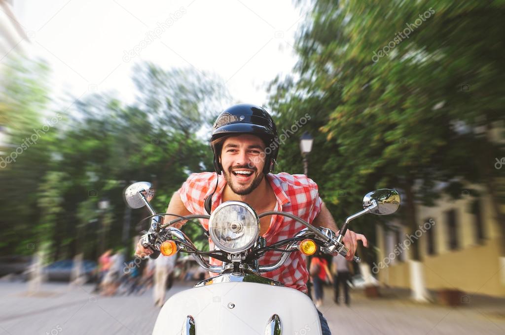 Young Man Riding Motor Scooter