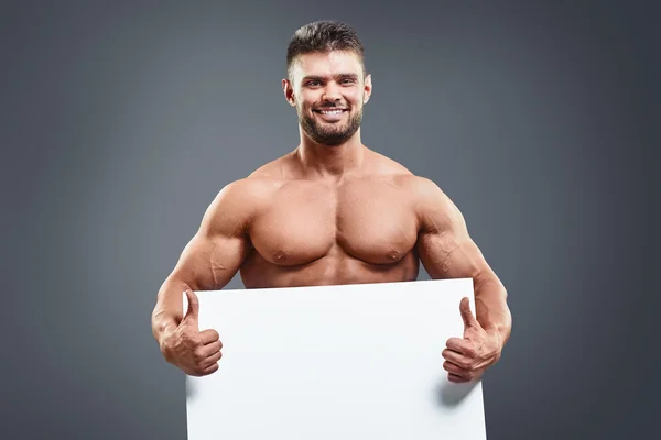Uomo muscoloso nudo che copre con un banner — Foto Stock