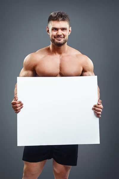 Hombre sin camisa mostrando y mostrando pancarta —  Fotos de Stock