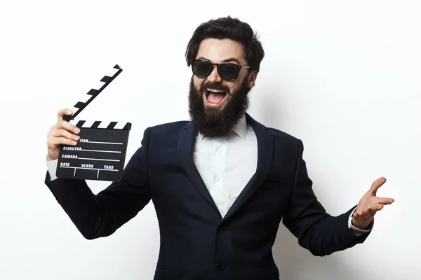 Man in a suit holding movie clapperboard — Stock Photo, Image