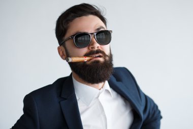 male with moustache and beard smoking cigar clipart