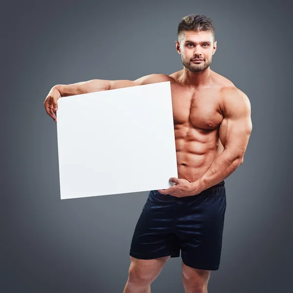 Uomo muscoloso nudo che copre con un banner — Foto Stock