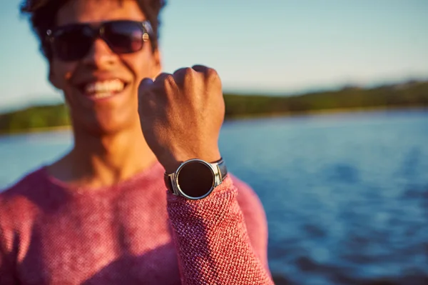 Young african man showing his watch — Zdjęcie stockowe