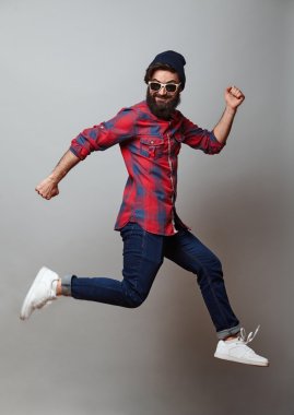 Jumping young bearded man clipart