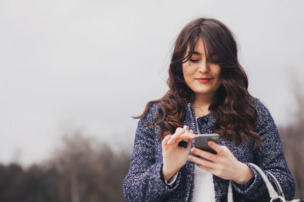 Closeup portrait young girl looking at phone messaging — Stock Photo, Image